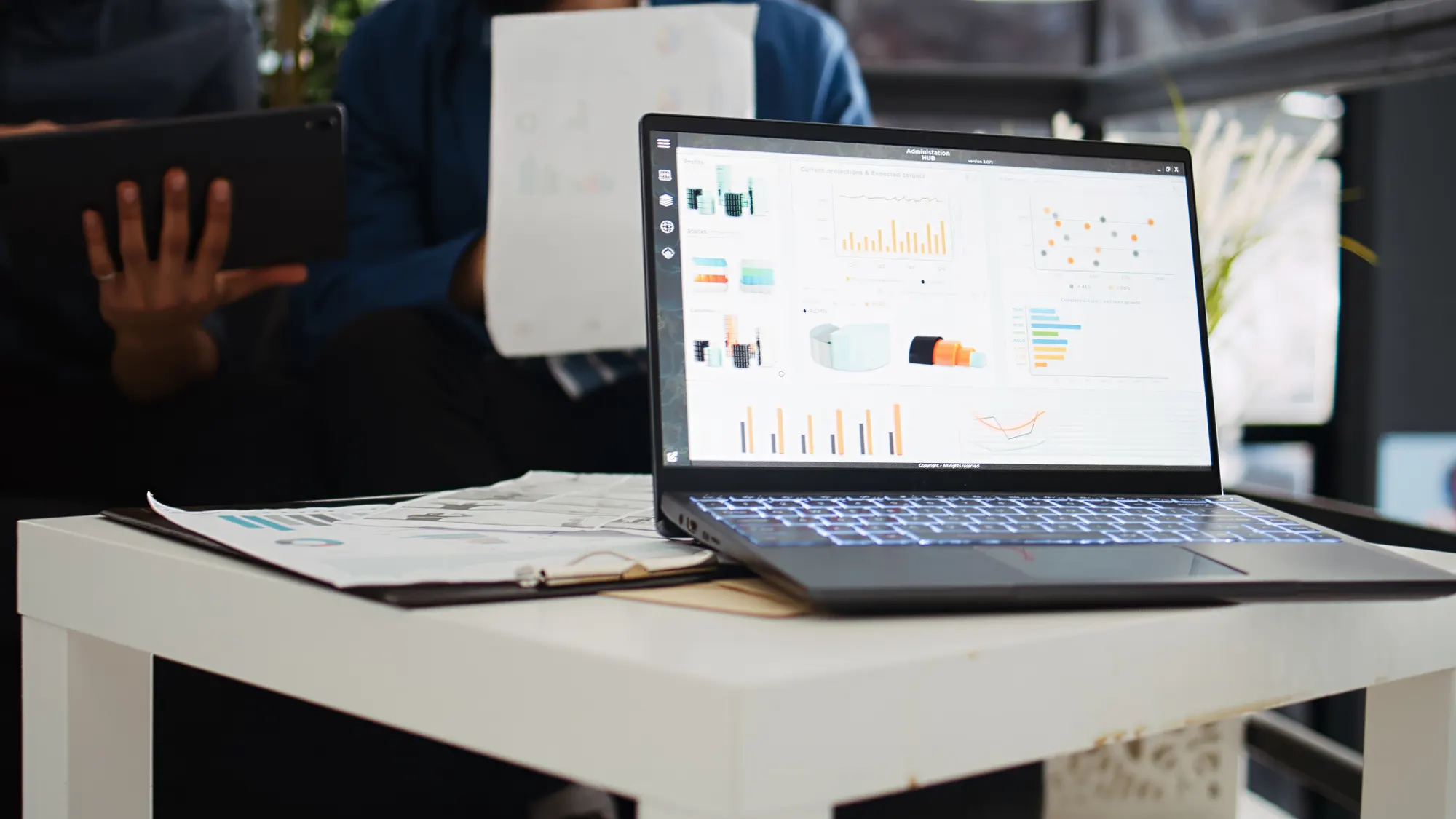 Two people reviewing analytics together on a laptop in a bright office